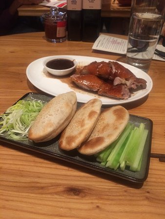 China Live signature dishes Sheng Jian Bao (Pan-Fried Pork Bums), Peking Duck, Dungeness Crab Wonton Soup, Char Siu Pork